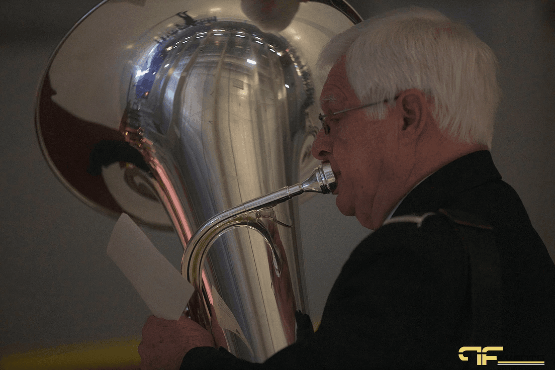 Tuba player reading music during the pre-game ceremony