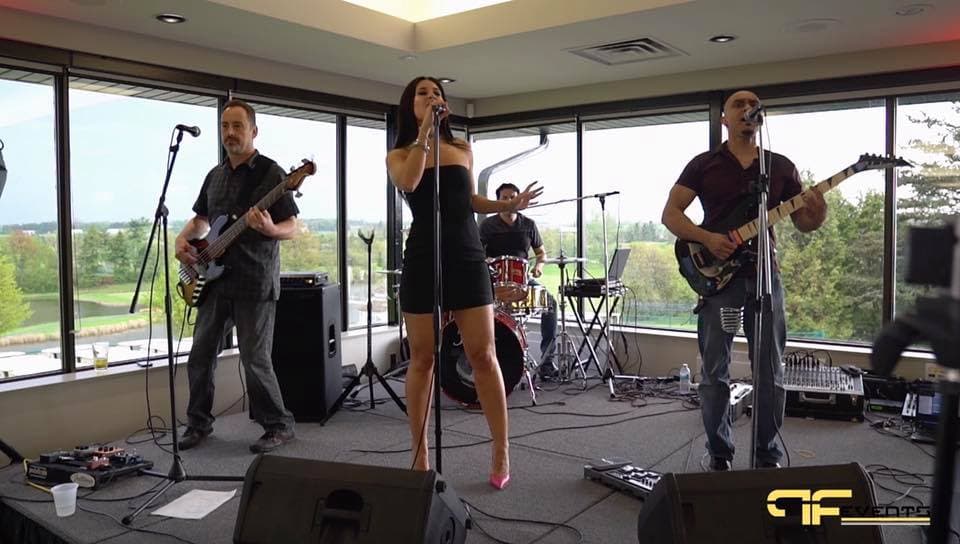 Four-piece band with wedges and mixer playing in the clubhouse