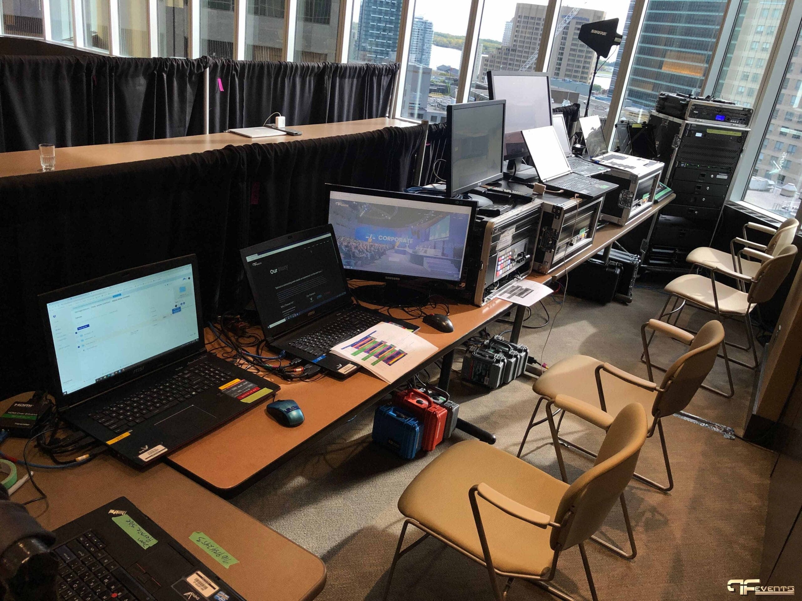 Tower-top control position with rack cases, laptops and a Shure antenna