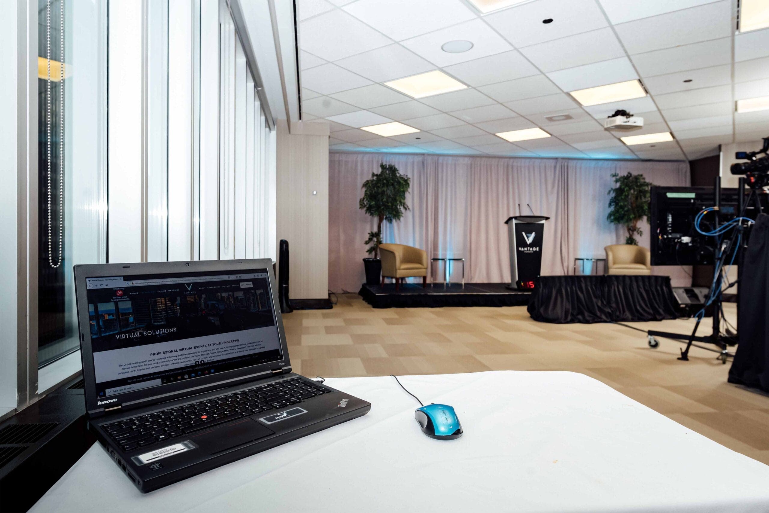 View from a laptop across the virtual studio to the stage and cameras