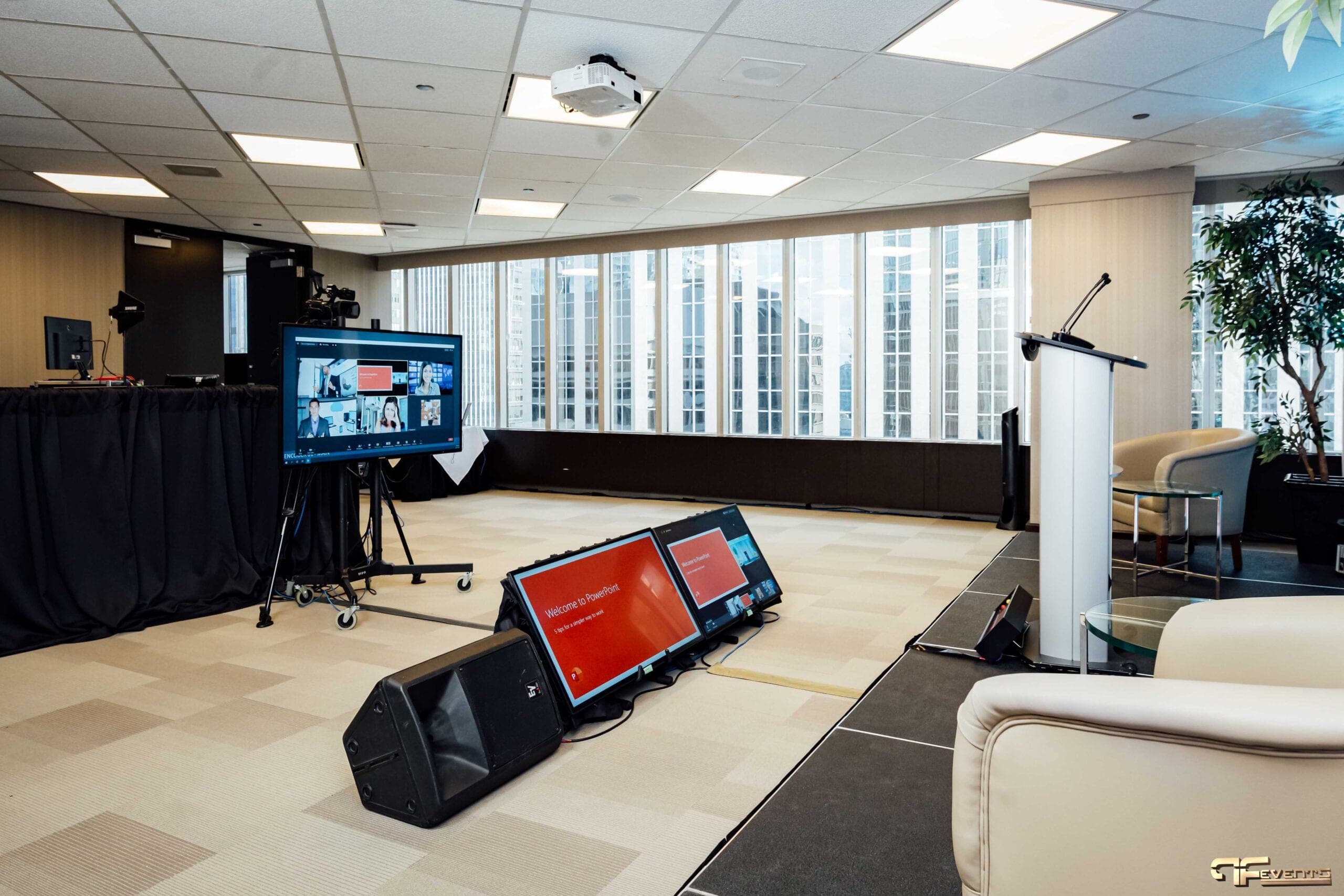 Studio room with window wall, floor monitors, wedge speaker and lectern